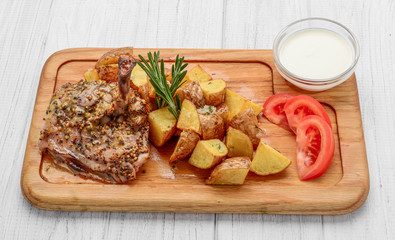 Grilled chicken with potatoes on the plate