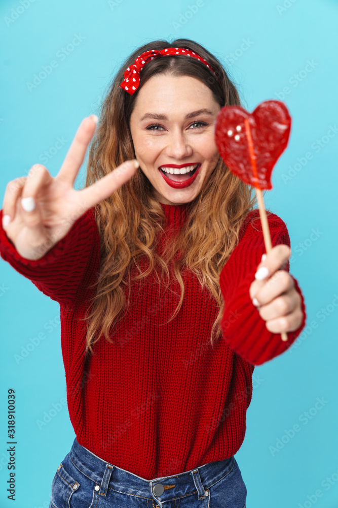 Sticker image of cheerful woman holding candy and gesturing peace sign