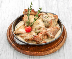 Cooked chicken breast seared in a cast iron skillet with creamy pan sauce