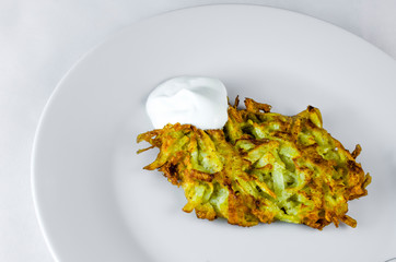 Potato pancakes with sour cream grate