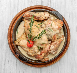 Cooked chicken breast seared in a cast iron skillet with creamy pan sauce