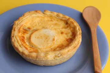 Delicious three cheese quiche in colored background