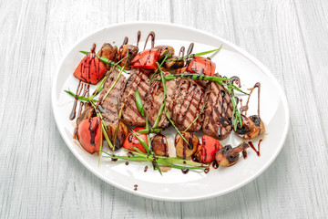 Grilled beef steak with mushrooms and tomatoes. Concept for healthy nutrition.