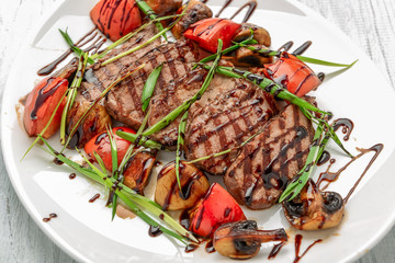 Grilled beef steak with mushrooms and tomatoes. Concept for healthy nutrition.