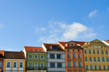 Typical colorful houses buildings with multicolored facade and windows, blue sky background in budweis czech republic