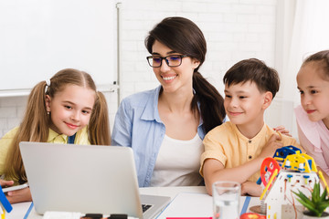 Stem lesson. Pupils and teacher watching robotics video
