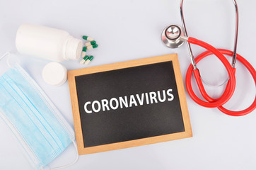 Text phrase Coronavirus on blackboard with medical equipment on white background. Novel coronavirus 2019-nCoV middle East respiratory syndrome coronavirus.