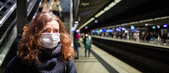 Naklejka na ściany i meble woman wearing surgical mask in crowd coronavirus