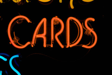 red cards neon sign on black isolated background copy space