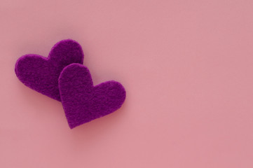 Two purple hearts on pink background. Symbols of love for lovers, Valentine's Day, Mother's Day, birthday greeting card design.