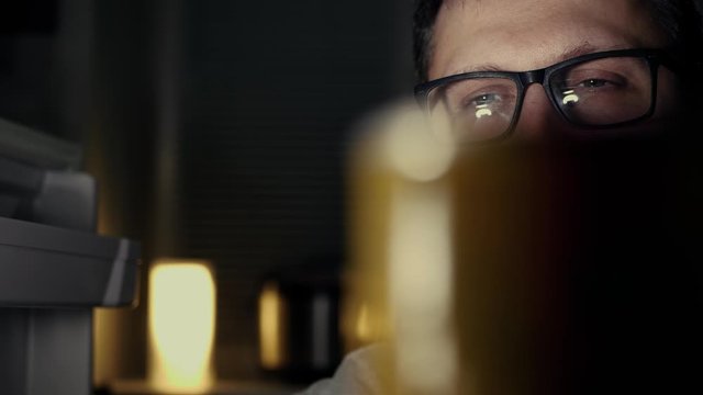 Hungry man is looking for food in refrigerator and finds only cucumber - he is upset. Diet, proper nutrition, fasting, healthy lifestyle, pregnancy, raw food, gluttony concept. Slow motion close up