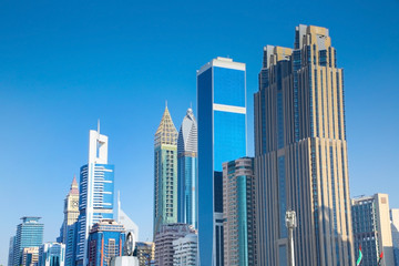 Fototapeta na wymiar Skyscrappers of office buildings & hotels on the skyline of Dubai, United Arab Emirates.