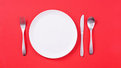 Valentine's Day meal design concept - Romantic plate dish set isolated on red background for restaurant, holiday celebration promotion, top view, flat lay.