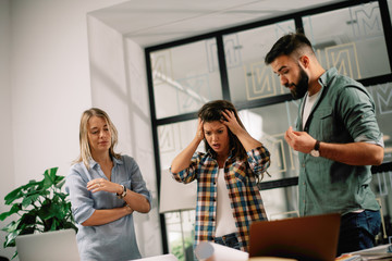 Colleagues arguing in office. Problem in team. Business people at meeting.	