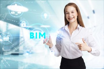 Business, Technology, Internet and network concept. Young businessman working on a virtual screen of the future and sees the inscription: BIM