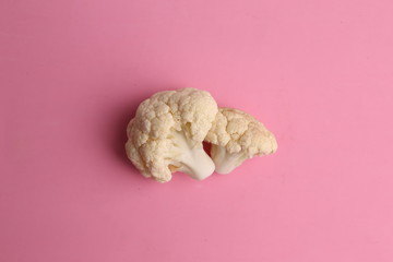Pieces of raw cauliflower in color background