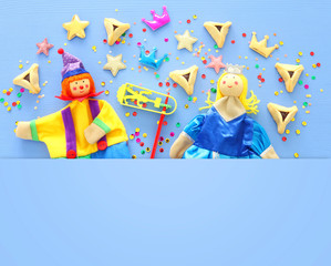 Purim celebration concept (jewish carnival holiday) over blue wooden background. Top view, Flat lay