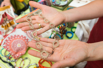 Closeup of handmade jewellery and accessories showcased on stalls. Original items sold by local...