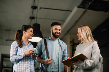 Colleagues in office talking an having fun. Friends working together.	
