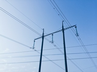Power lines on background of blue sky