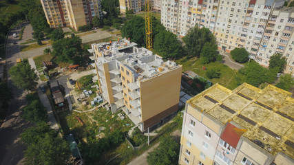 Fototapeta na wymiar Aerial Building Process of Construction Site. Engineers crane and city.