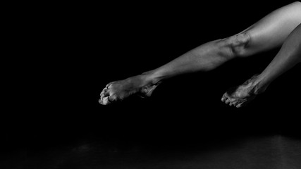 Ballet Dancer Point and Leg , intentionally shoot at High ISO to give grainy and dramatic feel, selective noise reduction applied, Low Key, Black and White Studio Shot - 318924269