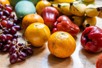 Many kind of fruits on wooden table
