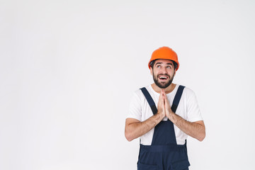 Dreaming young man builder in helmet