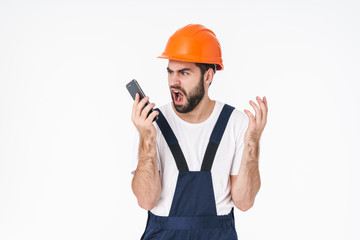Negative young man builder using mobile phone.