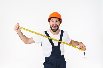 Happy young man builder holding centimeter.