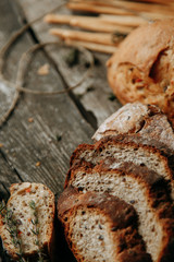 Set of sliced bread. Ingredients for cooking. Wooden background with bread. Empty space for signatures.