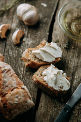  Italian food with spices. Bruschetta on a wooden background. Bread with cheese cream.