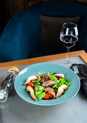 roast duck with pear and fresh salad on the table