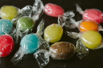 Heap of multicolor fruity candies as texture and background for design. Many different candies of different flavors.