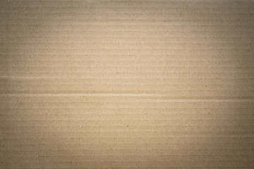 brown corrugated cardboard box background with vignette effect. Concept of packaging and shipping
