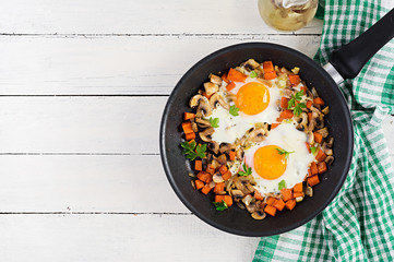 Ketogenic food. Fried egg, mushrooms and sliced pumpkin. Keto, paleo breakfast. Top view, overhead, copy space
