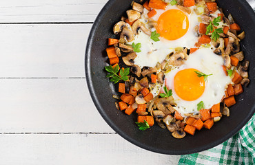 Ketogenic food. Fried egg, mushrooms and sliced pumpkin. Keto, paleo breakfast. Top view, overhead, copy space