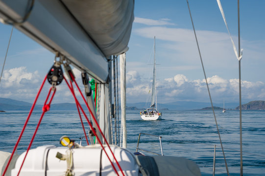 Sailing yachts fleet flotilla at Scotland waters. View from the deck. Oban, Hebrides islands.