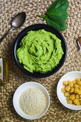 Colorful hummus bowls background. Different kinds of dips. Traditional hummus, herbs hummus, beetroot hummus, spread. Assorted meze and dips with crispy pita. Space for text. Meze and snacks concept