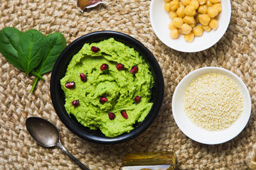 Colorful hummus bowls background. Different kinds of dips. Traditional hummus, herbs hummus, beetroot hummus, spread. Assorted meze and dips with crispy pita. Space for text. Meze and snacks concept