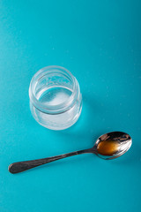 close up of honey jar on blue