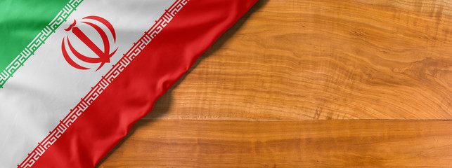 Fototapeta na wymiar National flag of Iran on a wooden background with copy space