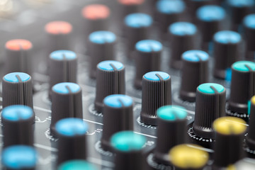 Close-up of volume buttons control of the audio mixer, knobs in audio mixing console. Selective focus