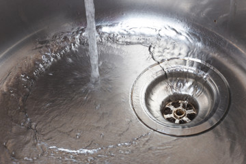 Water pours into the metal sink