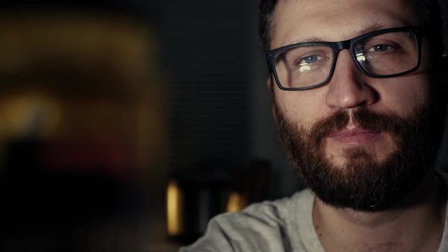Hungry man finds cake and carrots in refrigerator and upset man eats carrots. Diet, proper nutrition, fasting, healthy lifestyle, pregnancy, raw food, gluttony concept. Slow motion and close up