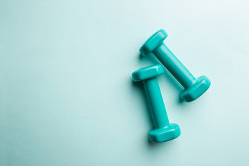 Blue dumbbells isolated on blue background, top view