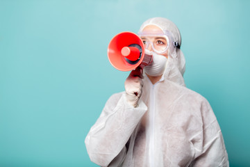 medic woman wearing protective clothing against the virus with megaphone