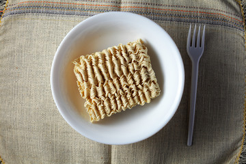 raw, brewed noodles on a light burlap background