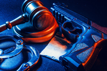 Judge gavel, handcuffs with white powder bag on dark table. Crime, robbery, drug trafficking concept