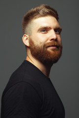 Fabulous at any age. Close up portrait of charismatic muscular 30-year-old man standing over dark...
